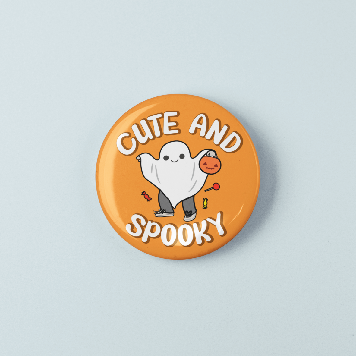 Button badge with ghost design and 'Cute and Spooky' text on a light blue background