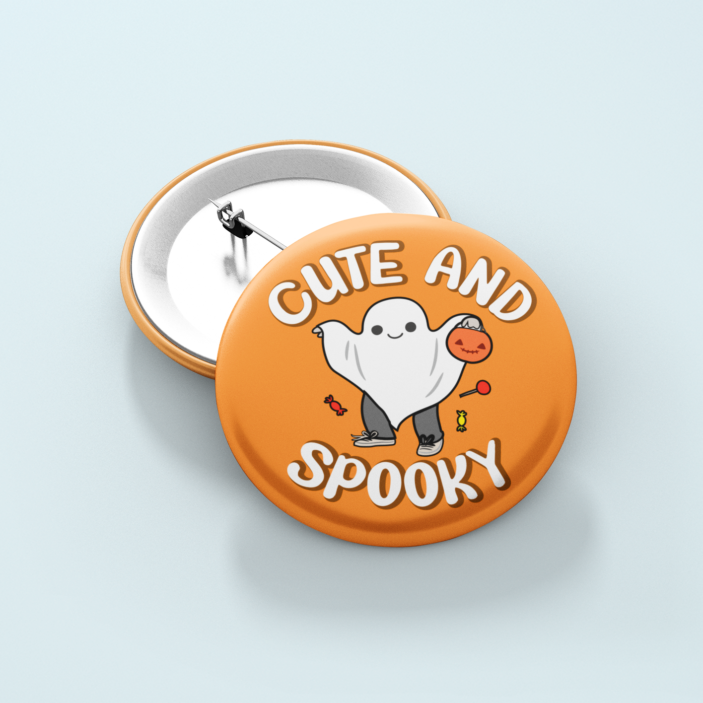Button badge with ghost design and 'Cute and Spooky' text on an orange background