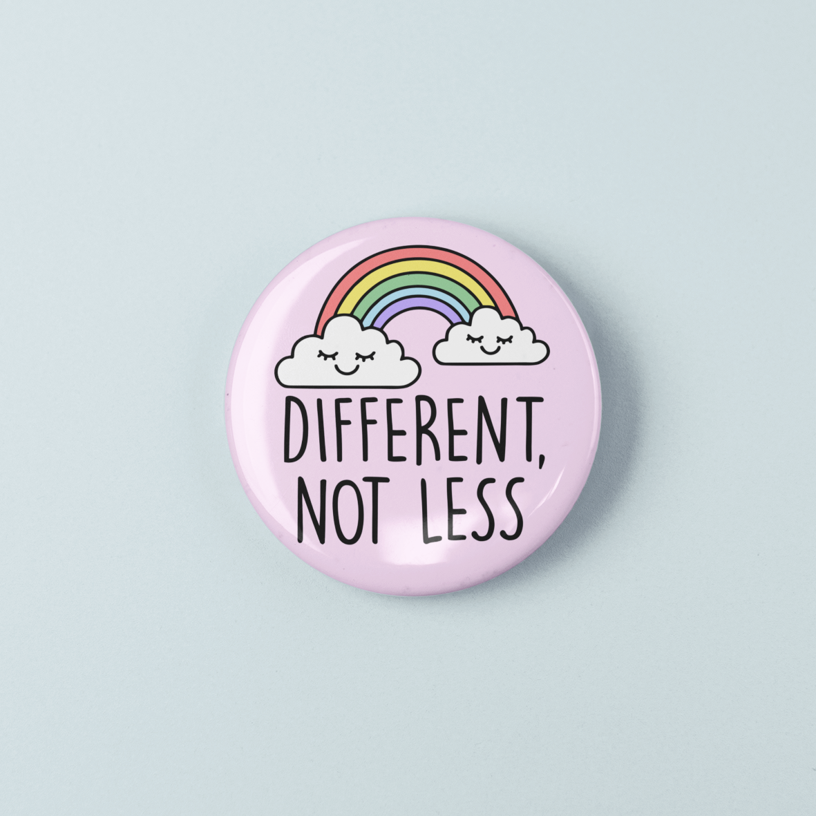 Button badge with rainbow and clouds design on a light blue background