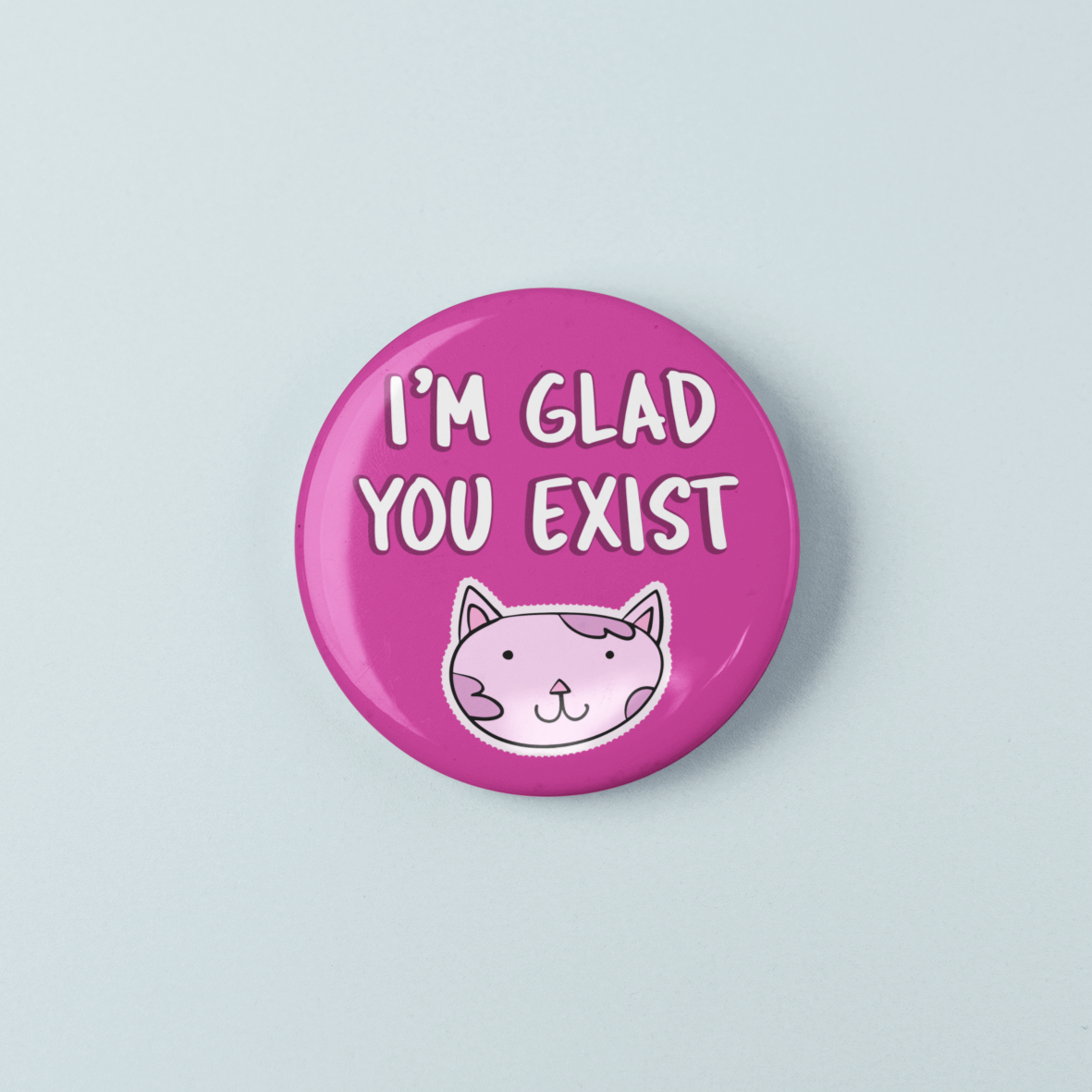 Pink button with a cat illustration and text 'I'm Glad You Exist' on a light blue background