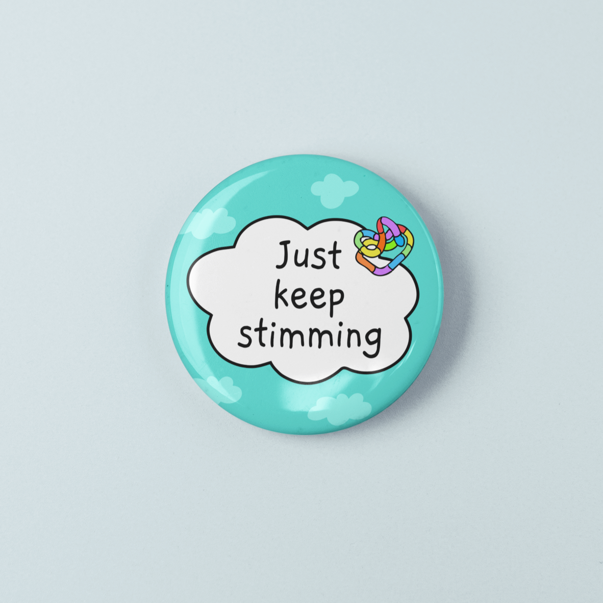 Button badge with 'Just keep stimming' text on a light blue background