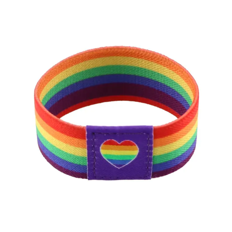 Rainbow striped wristband with a heart-shaped patch on a white background