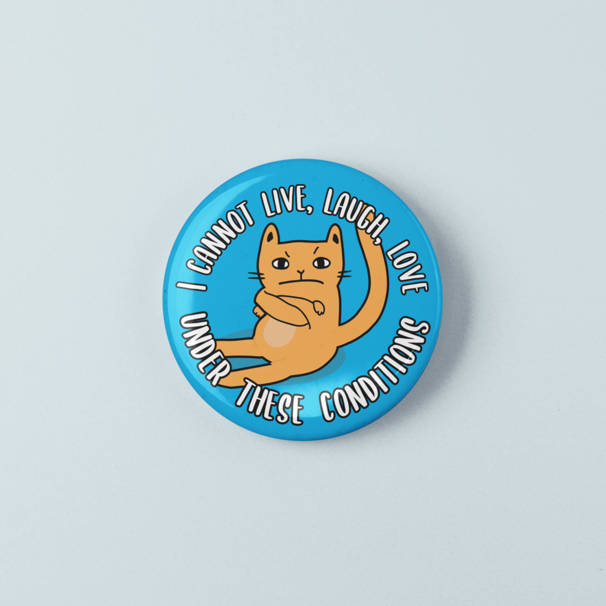 Button badge with a cat illustration and text on a light blue background