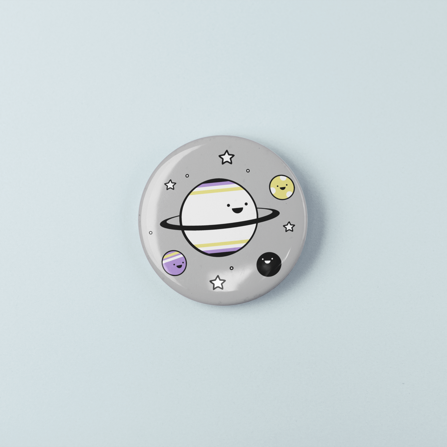 Button badge with a cartoon planet design on a light blue background