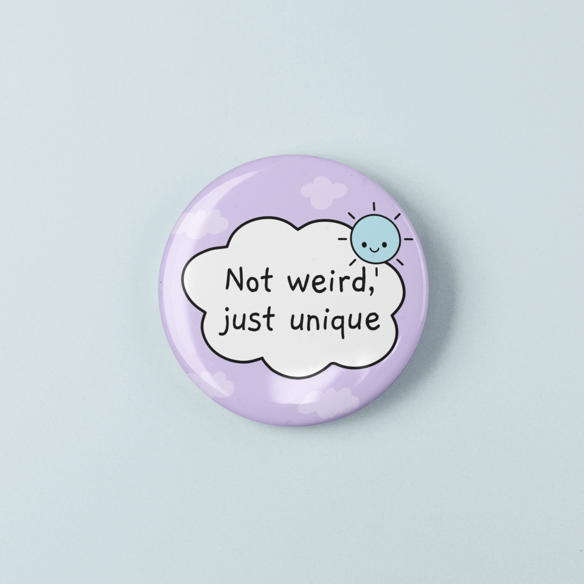 Button badge with 'Not weird, just unique' text on a light purple background