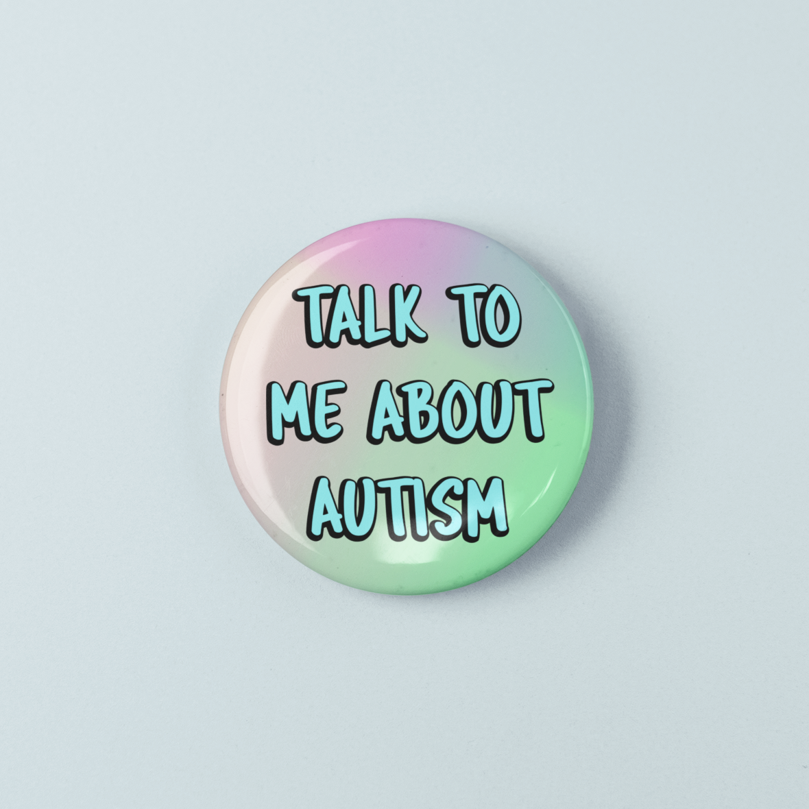 Round button with 'Talk to me about autism' text on a gradient background
