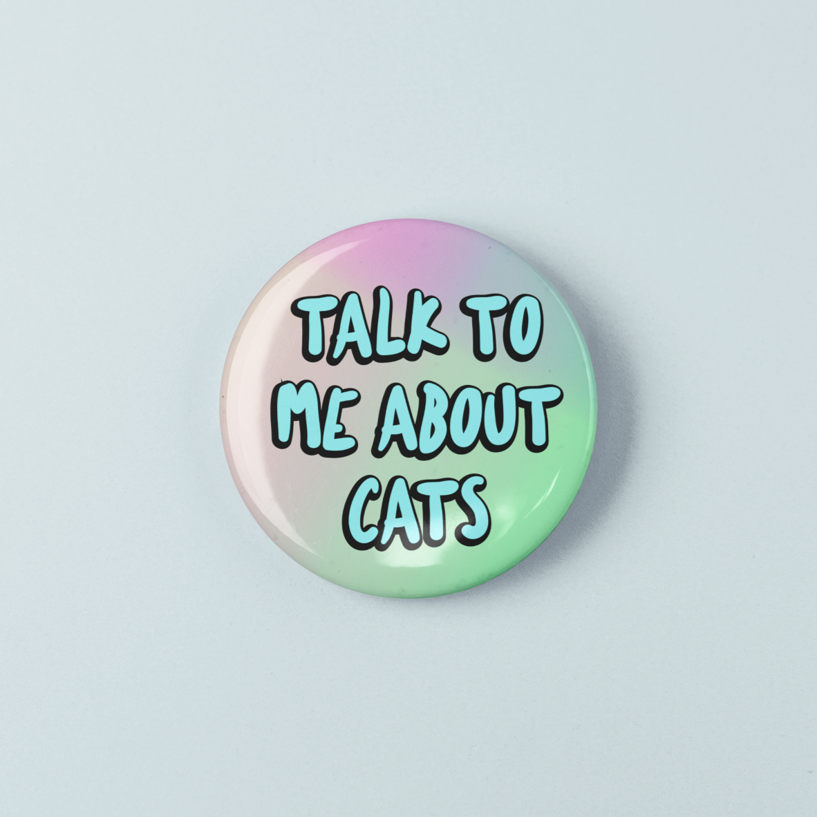 Round button badge with 'Talk to me about cats' text on a gradient background