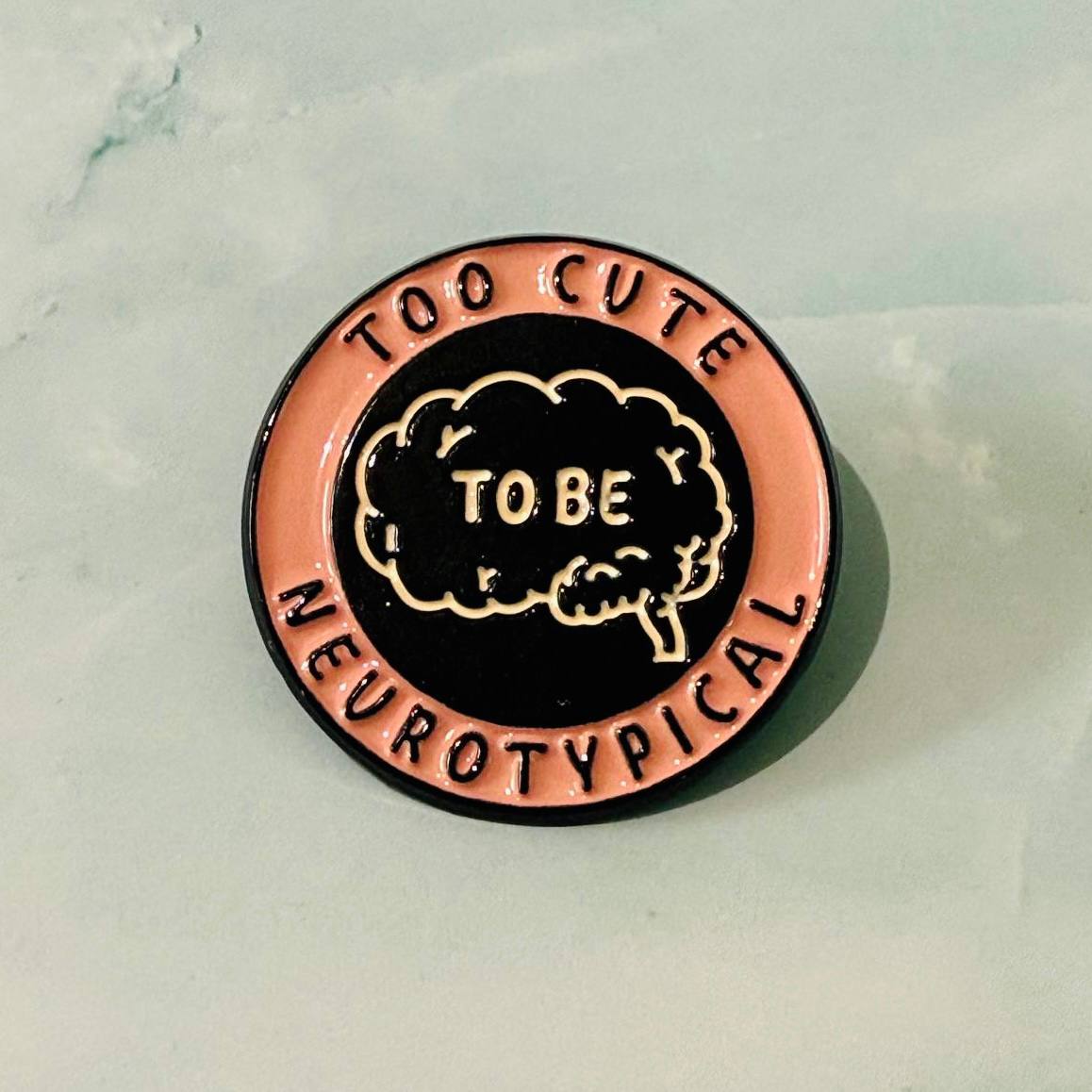 Pin with 'Too Cute to be Neurotypical' text on a light background