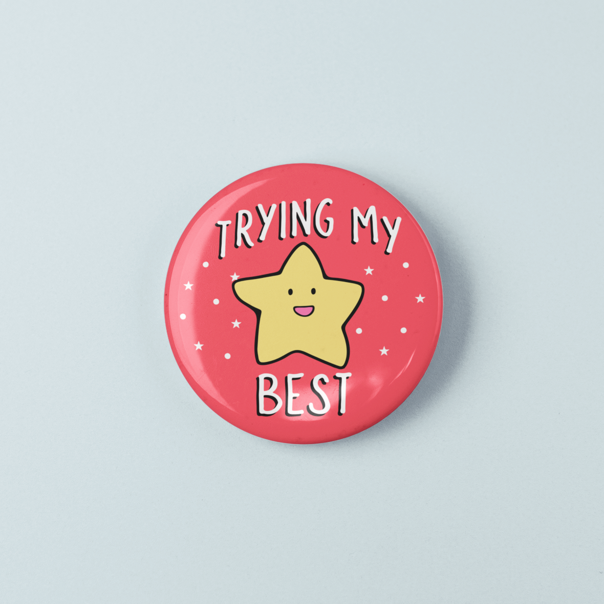 Button badge with a yellow star and text 'Trying My Best' on a pink background