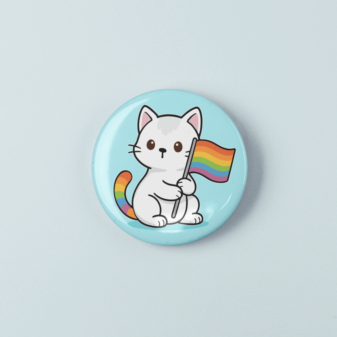 Button badge with a cat holding a rainbow flag on a light blue background