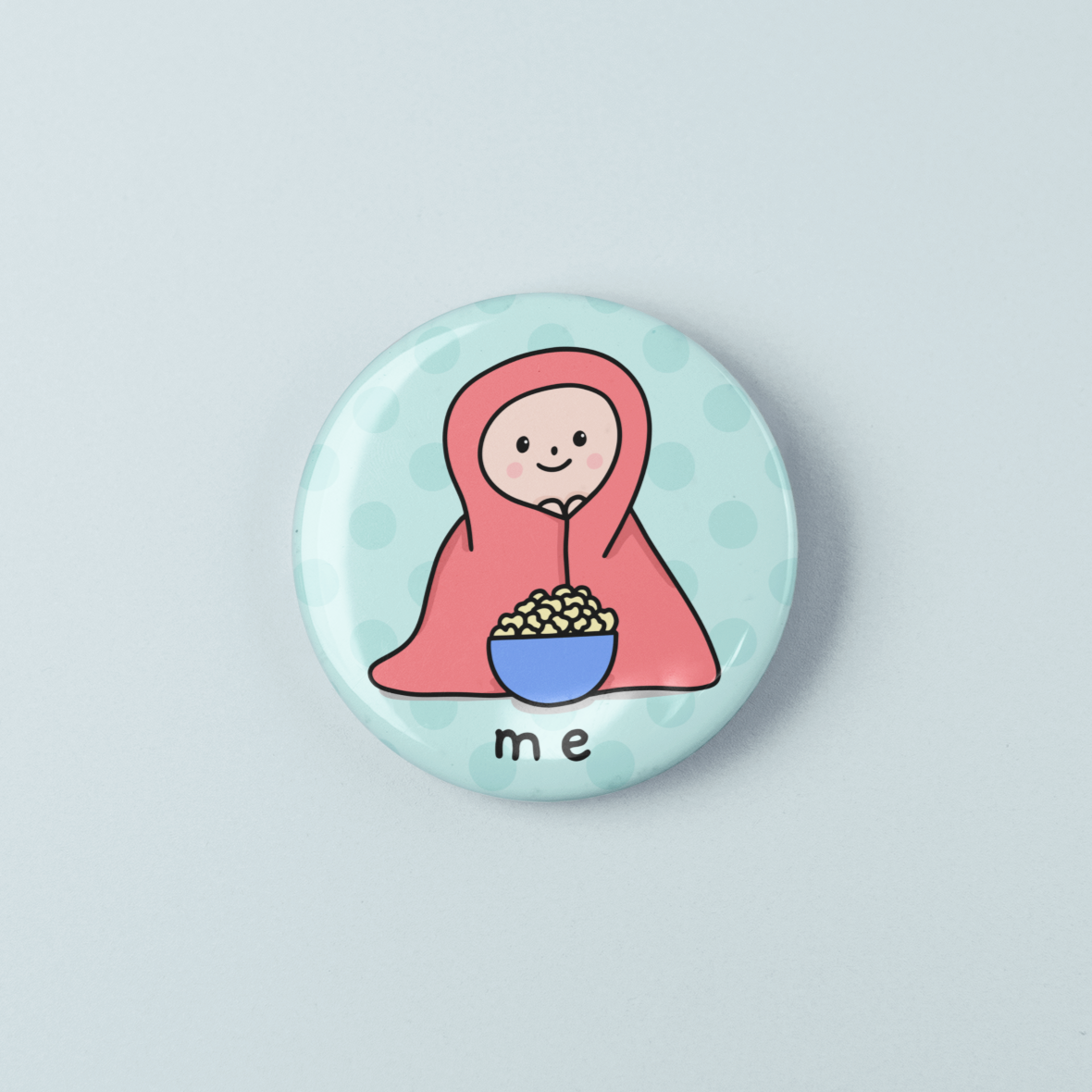 Button badge with a cartoon character holding a bowl labeled 'me' on a light blue background