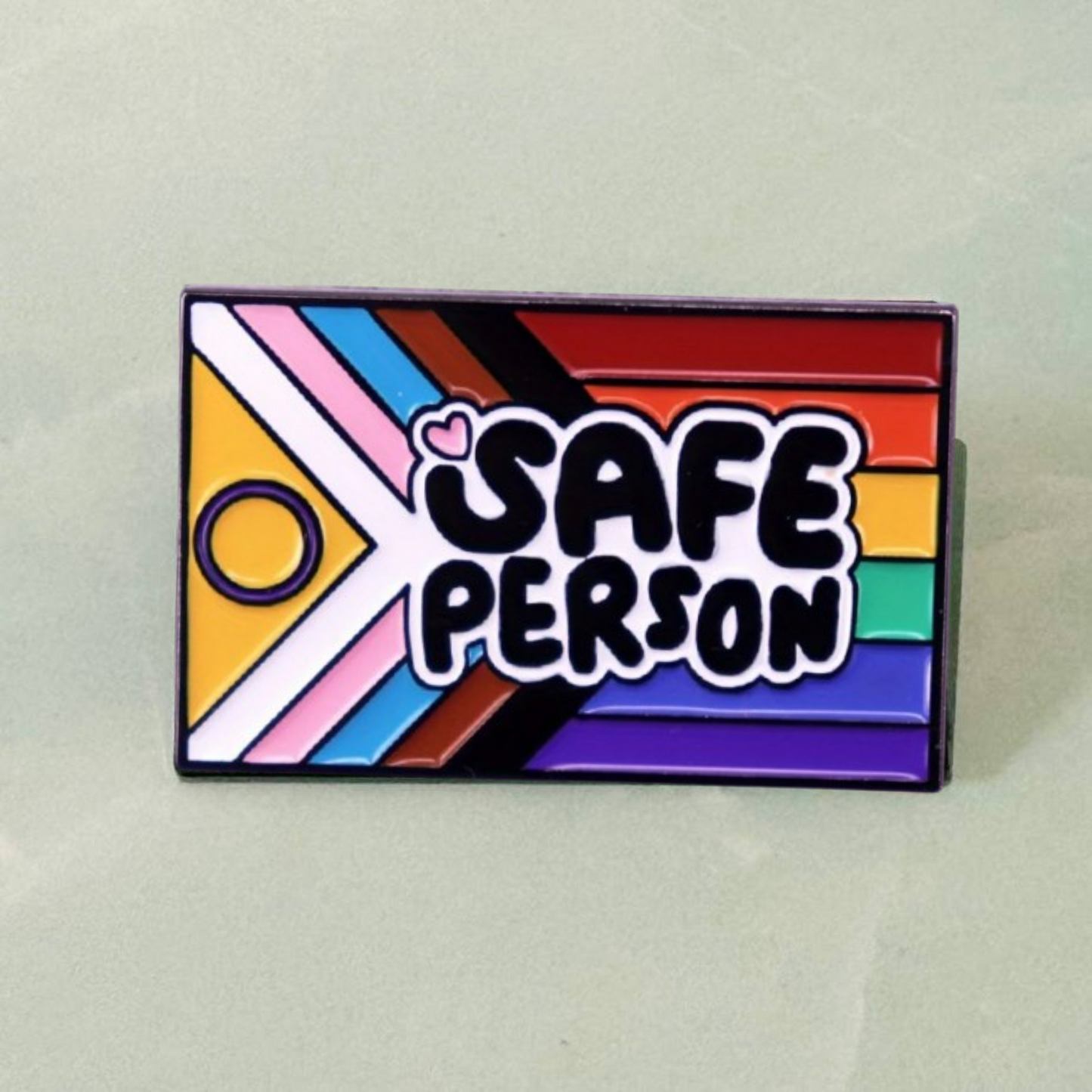 Colorful rectangular pin with 'SAFE PERSON' text on a light gray background