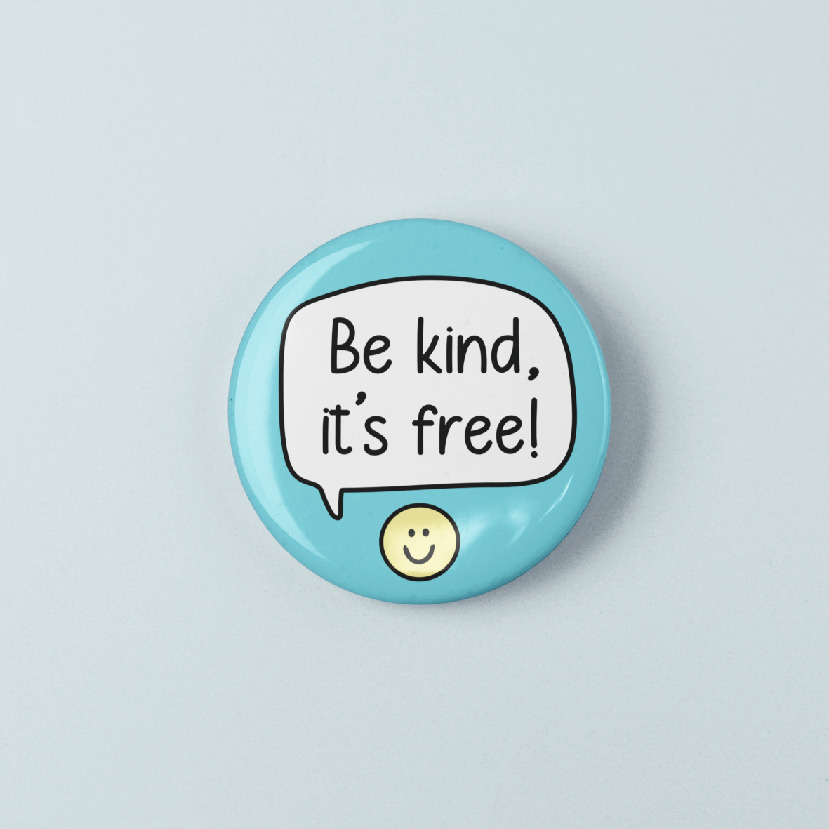 Button badge with 'Be kind, it's free!' text on a light blue background
