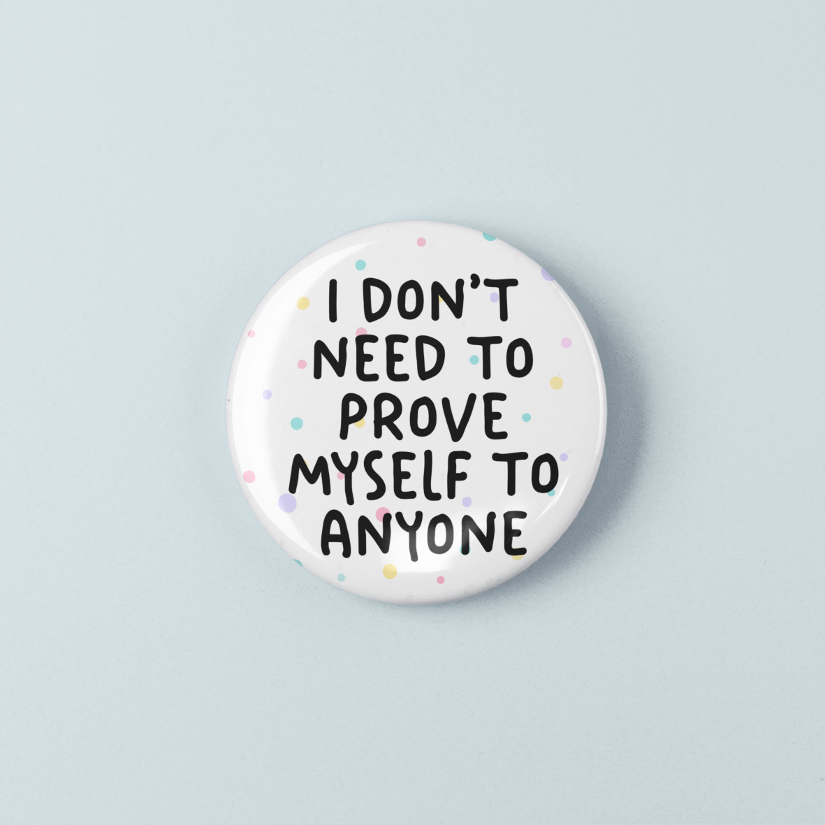 Button badge with text 'I don't need to prove myself to anyone' on a light blue background
