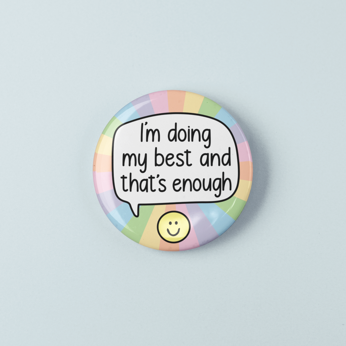 Button badge with motivational text 'I'm doing my best and that's enough' on a pastel rainbow background.