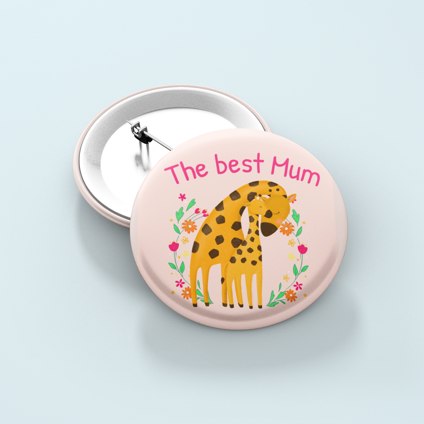 Button badge with a giraffe illustration and 'The best Mum' text on a light blue background