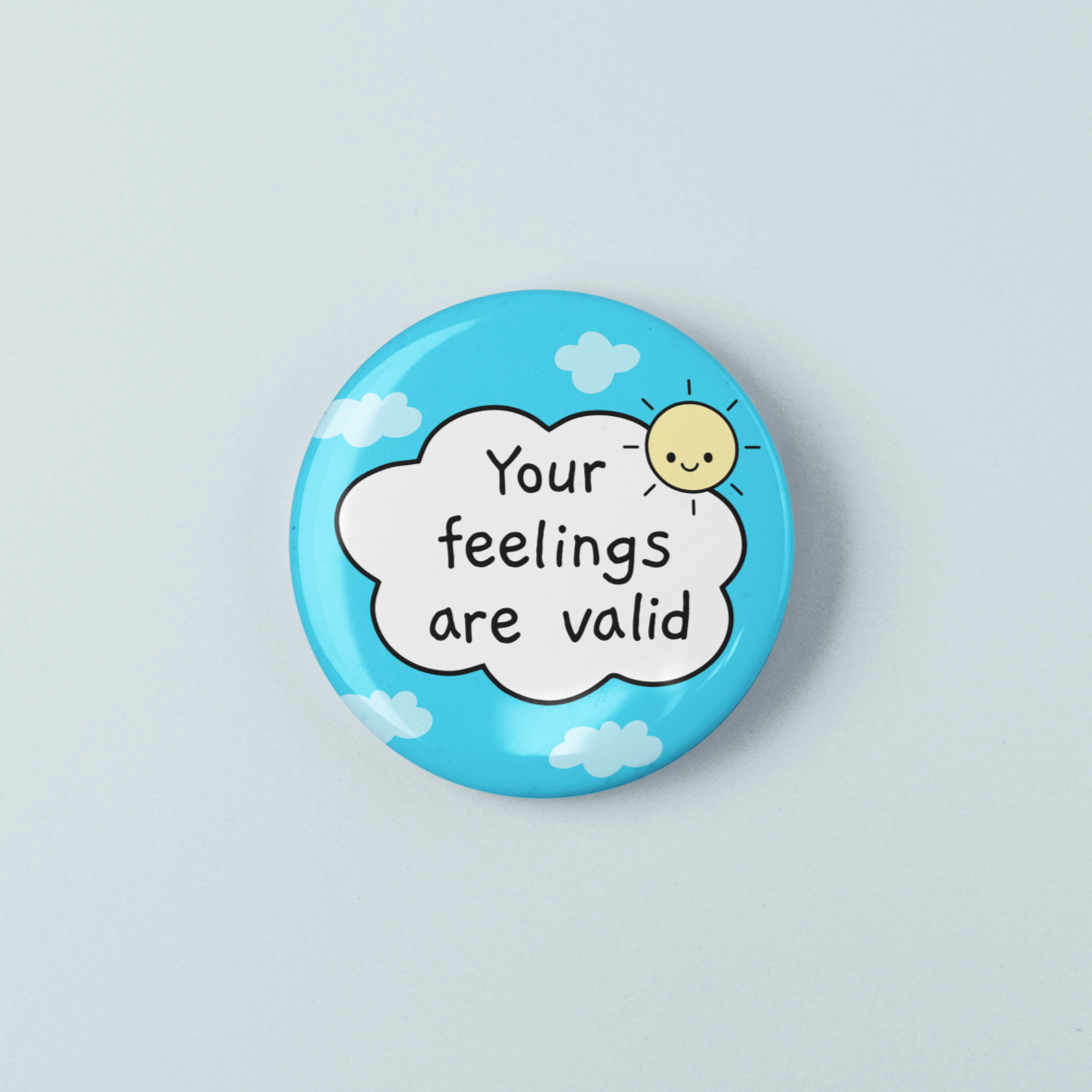 Button badge with 'Your feelings are valid' text on a light blue background
