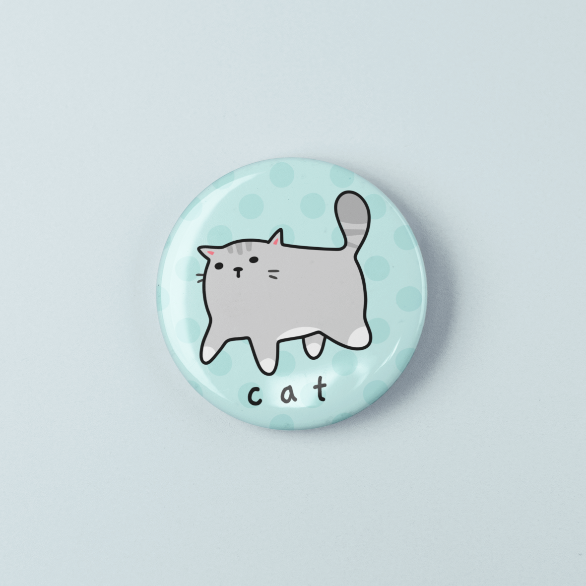Round button badge with a cat illustration on a light blue background