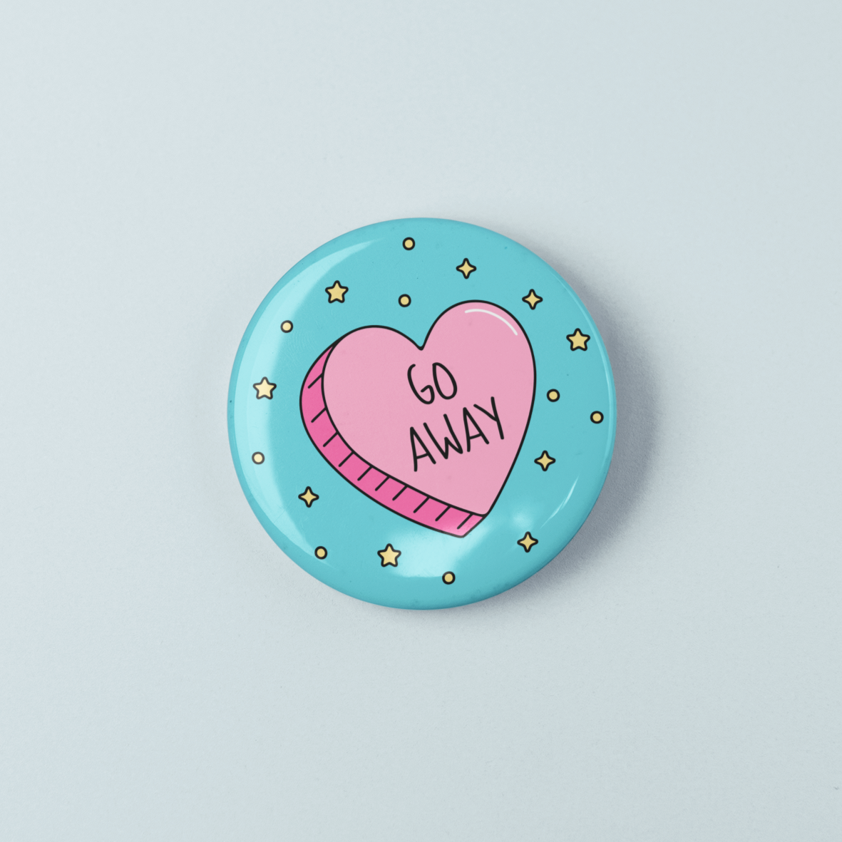 Button badge with a pink heart and 'GO AWAY' text on a blue background