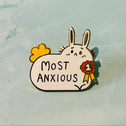 Pin with cartoon rabbit holding a sign saying 'Most Anxious' on a light blue background
