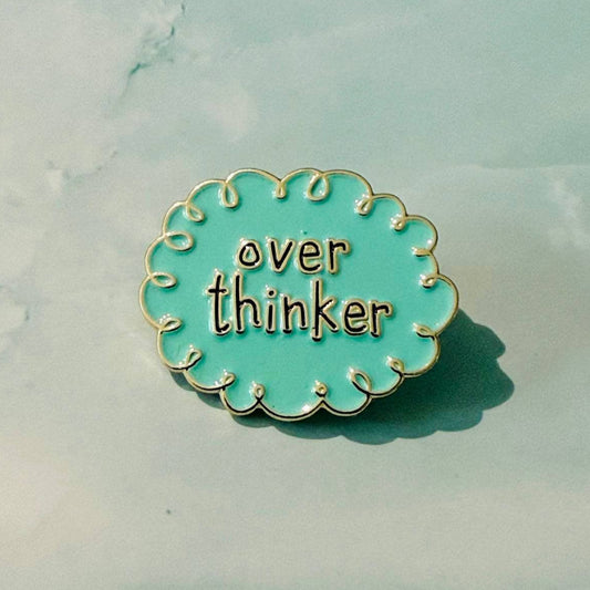 Pin with 'over thinker' text on a light blue background
