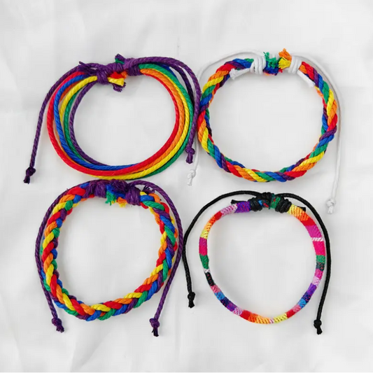Four colorful braided bracelets on a white background
